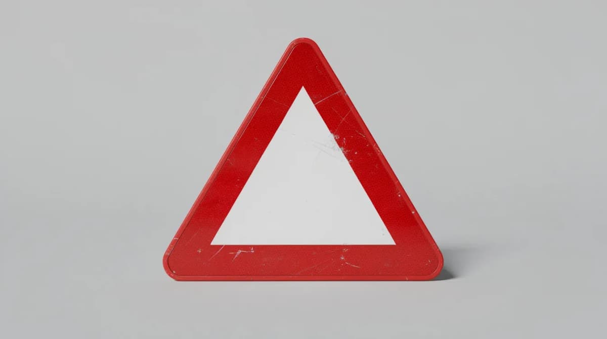 A red warning triangle sign is prominently displayed against a plain background, symbolizing caution and alertness. This image may evoke themes related to tax issues, such as an IRS notice or proposed changes to a tax return.